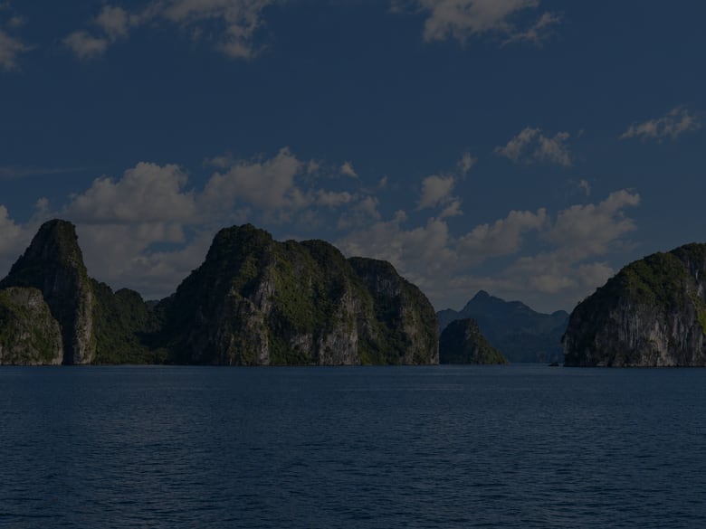 Bahía con montañas de piedra caliza al atardecer.